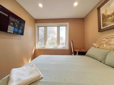 a bedroom with a bed and a window and a desk at Spacious Rooms with Bath Near Wonderland & Vaughan Mills Mall in Vaughan