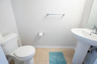 a bathroom with a white toilet and a sink at GlobalStay 3 Bedroom Townhouse Near Niagara Falls Brock University in Thorold