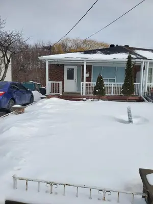 a house with a lot of snow in front of it at Maxwell Esabu in Toronto