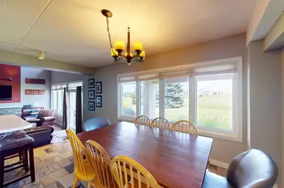 a dining room with a wooden table and chairs at Wintergreen 125 in Blue Mountains