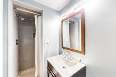 a white bathroom with a sink and a shower at Wintergreen 116 in Blue Mountains