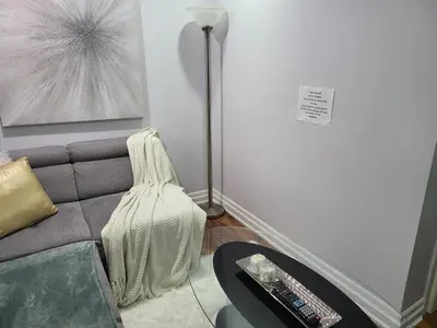 a living room with a couch and a floor lamp at Luxurious 1BR-1BA Apartment Bright Spacious with free parking-gc-1 in Brampton