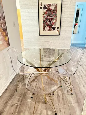 a glass table and two chairs in a room at Stunning 2 BD in heart of Toronto with Parking in Toronto