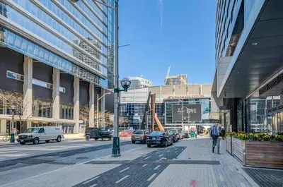 a busy city street with cars parked on the street at Stunning 2 BD in heart of Toronto with Parking in Toronto