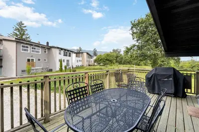 a patio with a table and chairs on a deck at Semi Detached Mountain View Chalet in Blue Mountains