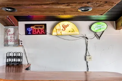 a room with signs on the wall of a bar at Semi Detached Mountain View Chalet in Blue Mountains