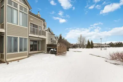 a house with snow in front of it at Blue Mountain Ski In Ski Out Resort Condo 2 Level in Blue Mountains