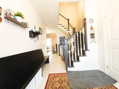 a hallway with a black and white stairway at Inspired Stay close to Niagara *4B & 2King Beds* in Thorold