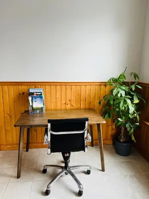 a wooden table with a chair and a laptop on it at Casa Maria Irena in Meaford
