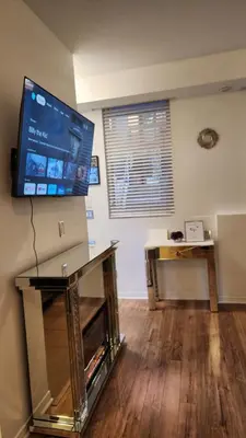 a living room with a large screen tv on the wall at Beautiful Townhouse Near Yorkdale Mall, Wilson Subway in Toronto