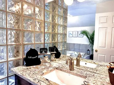 a bathroom with a sink and a counter top at Settlers Suites in Niagara on the Lake