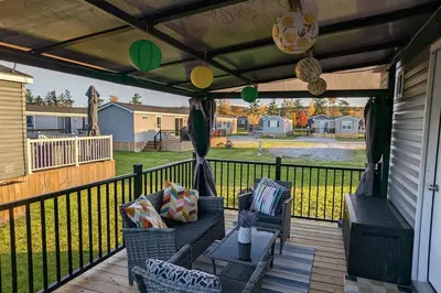 a patio with chairs and a couch on a deck at Subu's Paradise in Niagara in Niagara on the Lake