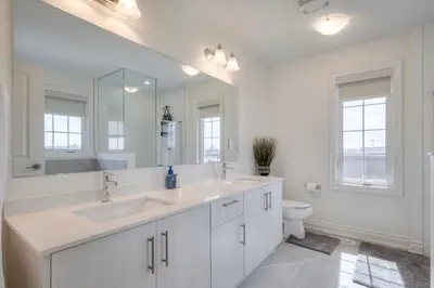 a white bathroom with a sink and a toilet at Masterfully Designed Private Suite in Bradford