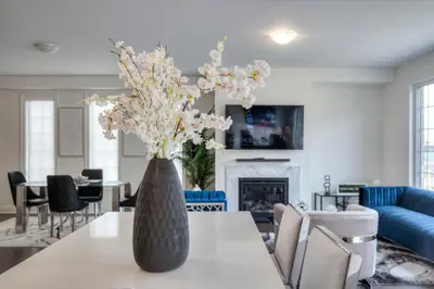 a vase with flowers on a table in a living room at Your Perfect Getaway Master Bedroom in Bradford