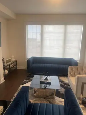 a living room with a blue couch and a table at The Ultimate Staycation in Bradford