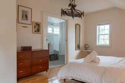 a bedroom with a bed and a dresser and a mirror at Elegant Elora Home with Stylish Décor in Elora