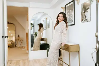 a woman in a white dress standing in front of a mirror at Elegant Elora Home with Stylish Décor in Elora