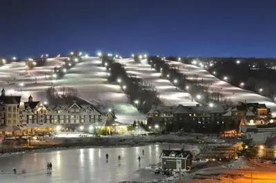 a group of buildings with snow and lights at Mountainside Studio Bliss Pool, Hot Tubs, At the Mountain in Blue Mountains