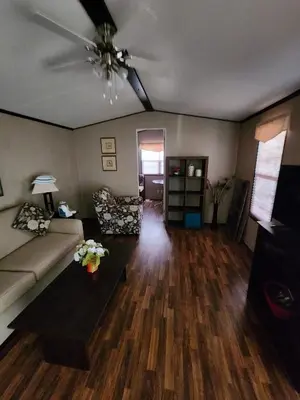 a living room with a couch and a ceiling fan at Falcon Cottages in Niagara on the Lake