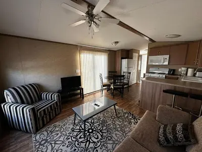 a living room with a couch and a table at Falcon Cottages in Niagara on the Lake